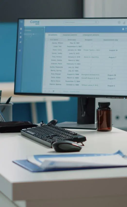Close up of desk with computer and medical instruments